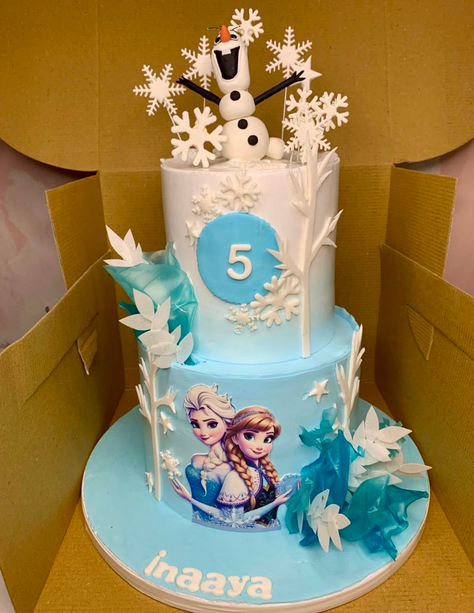 Two-tier Frozen themed birthday cake with Elsa, Anna and Olaf decorations